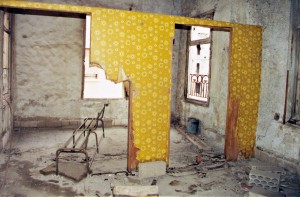 After a little wear and tear: My brother's bedroom was on the other side of what remains of the divider, mine on the near side.  We never slept there anymore after the war started, as the rooms gave onto the front line, and we left the house three months into the war. Most of the damage occurred afterward. It was still that way when I visited for the first time in 2000. Click on the image for larger view. (© FlaglerLive)