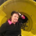 Angela TenBroeck inside a tractor wheel, an irony, considering that her sustainable farming methods avoid tractors. (Angela TenBroeck)