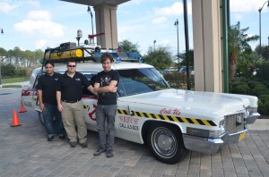 The men of 10th Voyage Studio, next to their Ghost Buster ECTO-1:  from left, Lenny Mosco, Scott Nance and Patrick Applolonia. (© FlaglerLive)