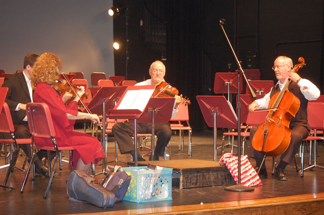 The Flagler Youth Orchestra's four music teachers, revving it up in rehearsal.