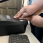 A Flagler County Sheriff’s Office Public Service Officer at the Flagler Sheriff’s Operations Center scans fingerprints for a background check. (FCSO)