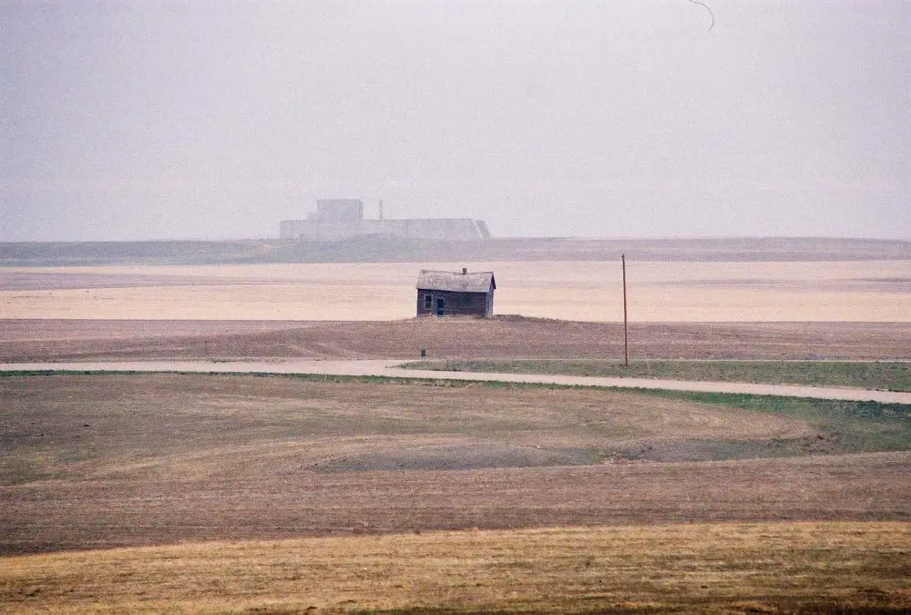 The unfinished, colossal PAR site--Perimeter Acquisition Radar--in the distance on the Montana prairie, one of the most massive buildings in the state, even in unfinished form, one of its most absurd, and one of the remarkable monuments to cold war futility on the planet. It's near Ledger, Montana. (© FlaglerLive)