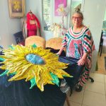 Artist Carol Brown, a resident of Daytona North, is shown with her draped hypertufa work “The Face of Ukraine.” (Daniel Johnston)