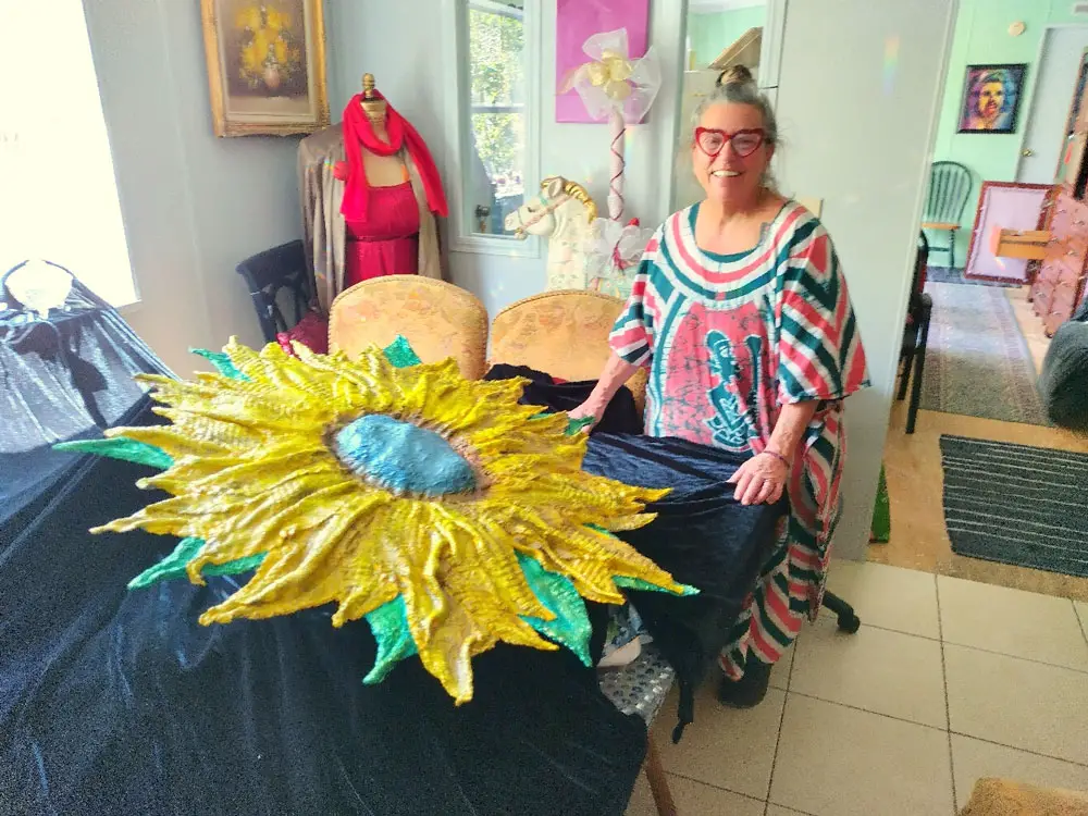 Artist Carol Brown, a resident of Daytona North, is shown with her draped hypertufa work “The Face of Ukraine.” (Daniel Johnston)