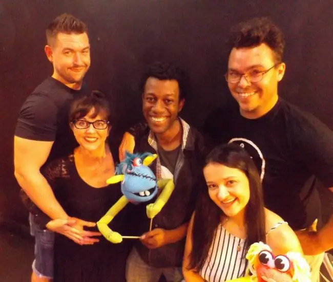 The cast of City Repertory Theatre’s production of “Hand to God” stars, from left: Bruce Popielarski as Timothy, Leigh Ann Singleton as Margery, Brent Jordan as Jason and the puppet Tyrone, Agata Sokolska as Jessica and the puppet Jolene, and Beau Wade as Pastor Greg. Wade also is directing the play. (© FlaglerLive)