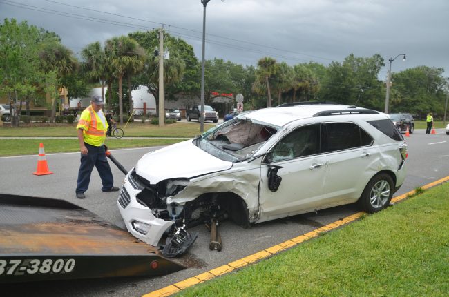 The Equinox was struck on the driver's side, with the violence of the crash severing the entire wheel from the body of the car. The wheel was flung by the side of the pond. Click on the image for larger view. (© FlaglerLive)