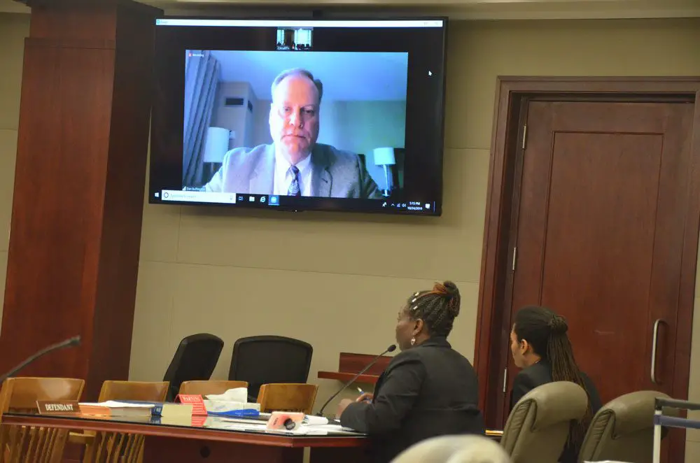 The fate of Victor Williams, who is sitting next to Assistant Public Defender Reginal Nunnally, largely rests on the testimony of Daniel Buffington, the pharmacologist piped in from his office during today's testimony, and on whether the jury will believe Buffington's analysis of impairment. (© FlaglerLive) 