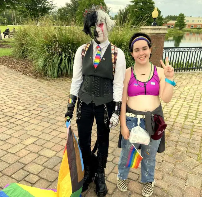 Crowlatay, a 20-year-old Palm Coast resident from Washington state, and Casper, a 14-year-old Buddy Taylor Middle School student, met for the first time at the Flagler Pride event on Saturday. (© FlaglerLive)