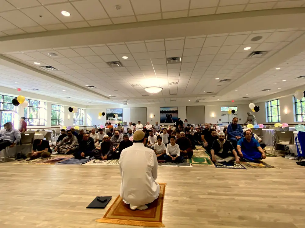 Acting Imam Mohamed, front, leads members of the Islamic Center of Palm Coast in salah (prayer) this morning at the Palm Coast Community Center, by reciting passages from the Quran and bowing towards Mecca. (© FlaglerLive)