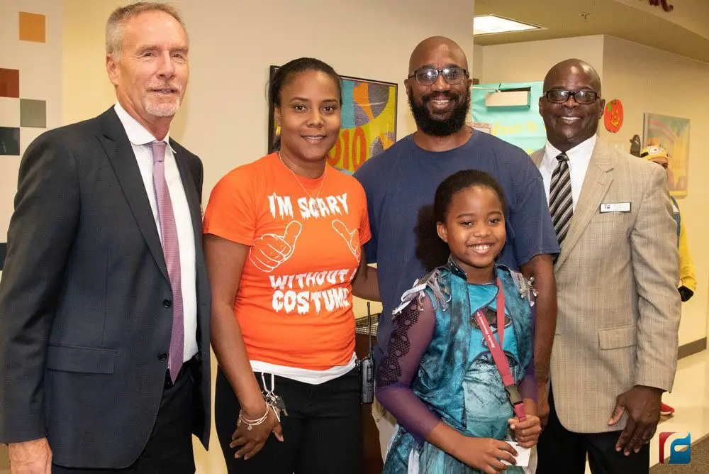 From left, Superintendent James Tager, LaShakia Moore, Tirrell Moore (husband), Kennedy Moore (daughter), Dr. Earl Johnson, Exec. Dir. Leadership and Operations. (Flagler Schools)