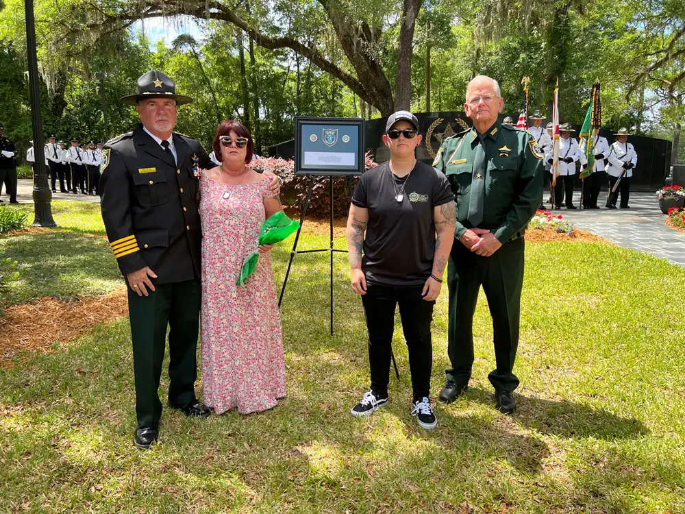 Sheriff Rick Staly and Chief Mark Strobridge with Detention Deputy First Class Paul Luciano's family at the fallen officers' memorial in Tallahassee today. (FCSO)