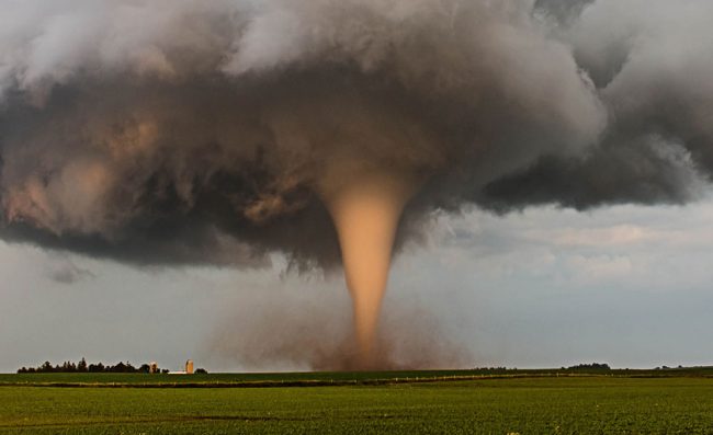 A tornado churns up dust in the sunset light near Traer, Iowa by Brad Goddard, Orion, Ill. (NOAA)