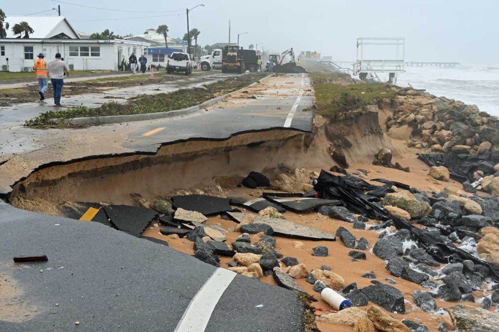 Several segments of State Road A1A in Flagler Beach and south of the city were carved out by waves unleashed by Tropical Storm Nicole, just three years after the Departmnent of Transportation completed a $22.4 millio project to rebuild the road and add a sea wall further north. The sea wall held. The road did not. Two DOT contractors were already at work during the storm Thursday, dumping sand on breaches to stabilize what was left of the road. (© FlaglerLive)