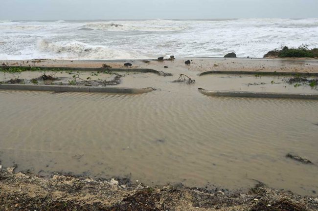 An area of A1A around South 10th Street, the dunes eviscerated, the road turned to river. (© FlaglerLive)