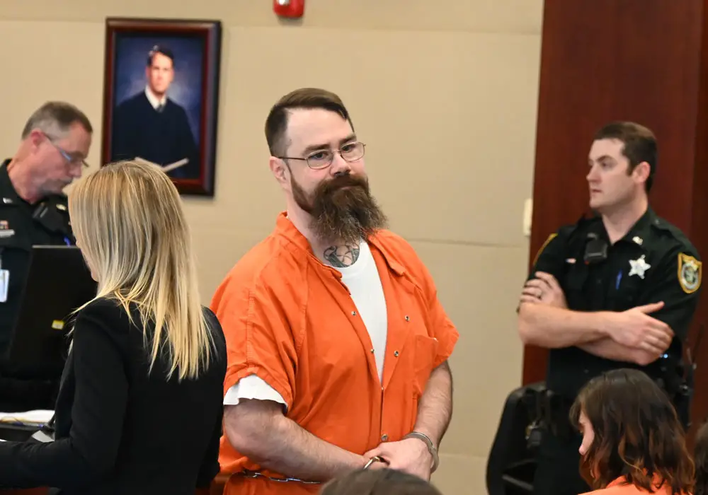 Aaron Thayer on several occasions today looked at his wife and daughter, who were in the courtroom. He pleaded to several charges, including attempted murder. His wife was the victim. (© FlaglerLive)