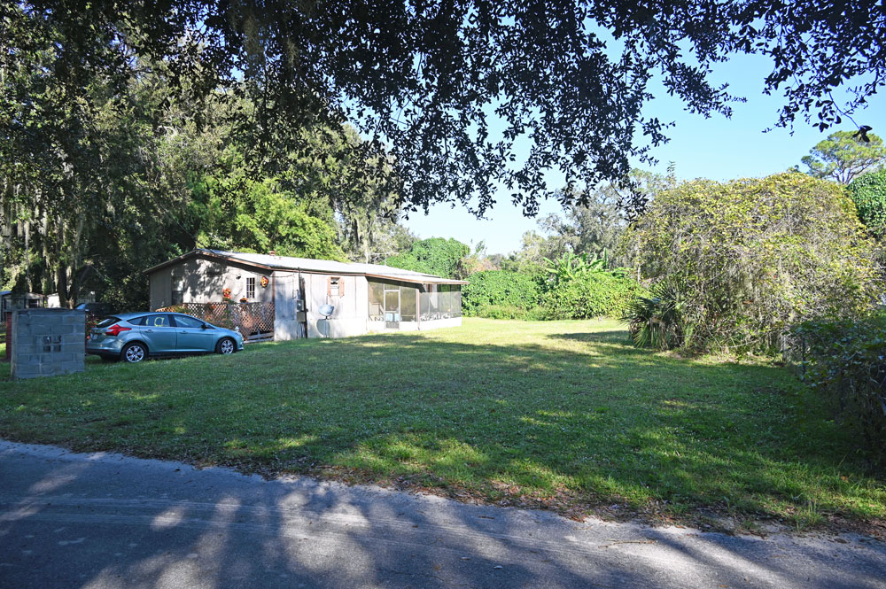 The small, treeless lot across the street from the church that could accommodate parking. (© FlaglerLive)