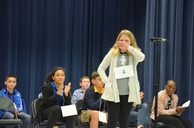 Addison Davis, a fifth grader at Old Kings Elementary, immediately after spelling 'renovate' and winning the 2019 Flagler County Spelling bee at Wadsworth Elementary Wednesday evening. (© FlaglerLive)