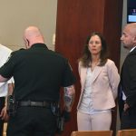 Melvin Adona, left, after being sentenced to 10 years in prison, as he was about to be finger-printed, with Assistant State Attorney Melissa Clark and defense attorney Aaron Delgado to the right. (© FlaglerLive)