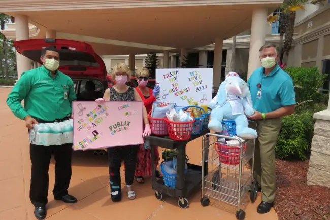 AdventHealth Palm Coast's John Subers, right, and other AdventHealth officials took delivery of gifts delivered by Flagler Beach resident Wanda Duff and other volunteers who organized a gift drive with Duff. (*Wanda Duff for FlaglerLive)