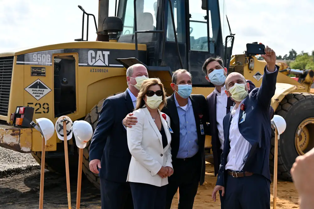 AdventHealth's top executives after filming today at the 11-acre site oif the new, $145 million hospital and medical office building on Palm Coast Parkway. From right, AdventHealth Palm Coast COO Wally de Aquino, Central Region CEO David Ottati, AdventHealth Palm Coast CEO Ron Jimenez, Chief Nursing Officer Kathy Gover, and Chief Financial Officer Mark Rathburn. (© FlaglerLive)