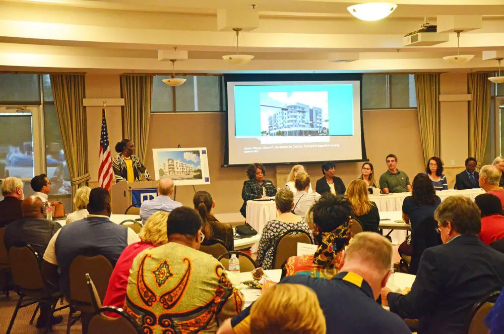 Sandra Shank, who chairs the county’s affordable housing advisory committee, introduced the panelists at Tuesday evening's forum on affordable housing at the Flagler County Association of Realtors. (© FlaglerLive)