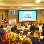 Sandra Shank, who chairs the county’s affordable housing advisory committee, introduced the panelists at Tuesday evening's forum on affordable housing at the Flagler County Association of Realtors. (© FlaglerLive)