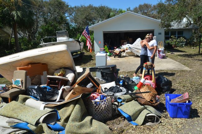 AJ Neste, his wife Megan and their three young children have lost just about everything to flooding at their house on South Flagler Avenue, yet today they had zero self-pity and nothing but praise for the comfort and help they've been receiving from friends and strangers. Their story is not unique, neither for its losses nor its helping hands. Click on the image for larger view. (c FlaglerLive)