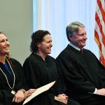 County Judge Andrea Totten, center, at her investiture in November 2019, with County Judge Melissa Distler and Circuit Judge Terence Perkins. (© FlaglerLive)