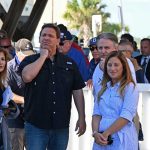 Flagler County Engineer Faith al-Khatib this morning explained to Gov. DeSantis the loss of yet another 160 feet of the Flagler Beach pier, after a similar loss during Hurricane Matthew. To the governor's right were Flagler Beach Mayor Suzie Johnston and City Manager William Whitson. (© FlaglerLive)