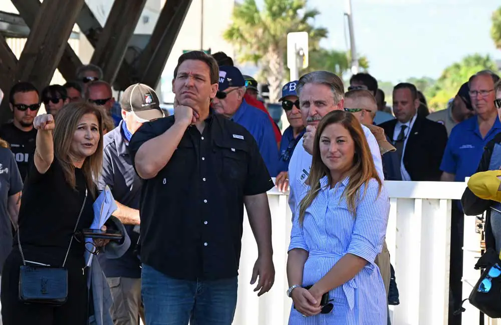 Flagler County Engineer Faith al-Khatib this morning explained to Gov. DeSantis the loss of yet another 160 feet of the Flagler Beach pier, after a similar loss during Hurricane Matthew. To the governor's right were Flagler Beach Mayor Suzie Johnston and City Manager William Whitson. (© FlaglerLive)