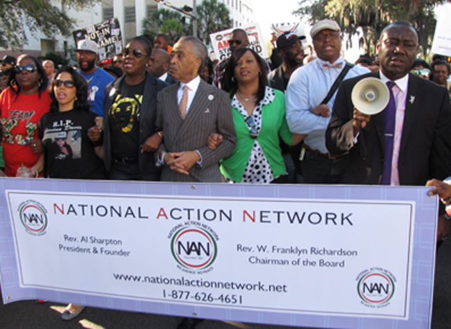 Rev. Al Sharpton (center) marches with parents and family of Trayvon Martin, Jordan Davis and others in Tallahassee on Monday in a call for a repeal of Florida's Stand Your Ground law.