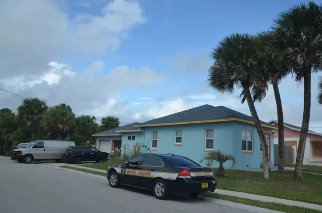 The Medical Examiner and Flagler Beach police were at Alf Olsen's property the morning of Oct. 6 as skies were darkening and the city was evacuating. Olsen, a resident at that house for the past five years, was found dead in his garage. (© FlaglerLive)