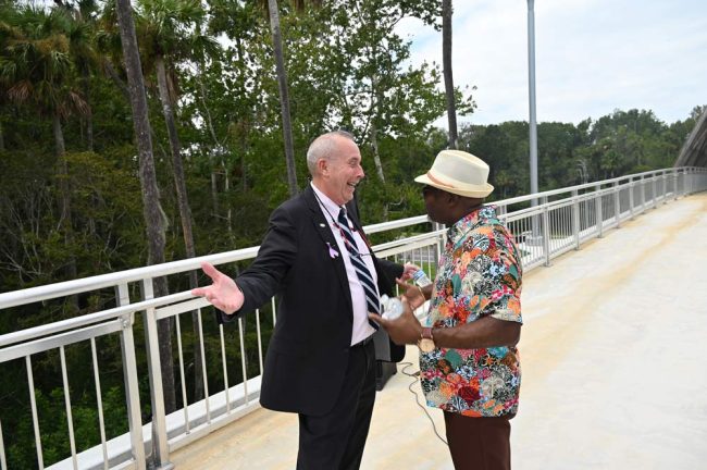 Palm Coast Mayor David Alfin, left, and Bunnell City Manager Alvin Jackson connect at the bridge. (© FlaglerLive)