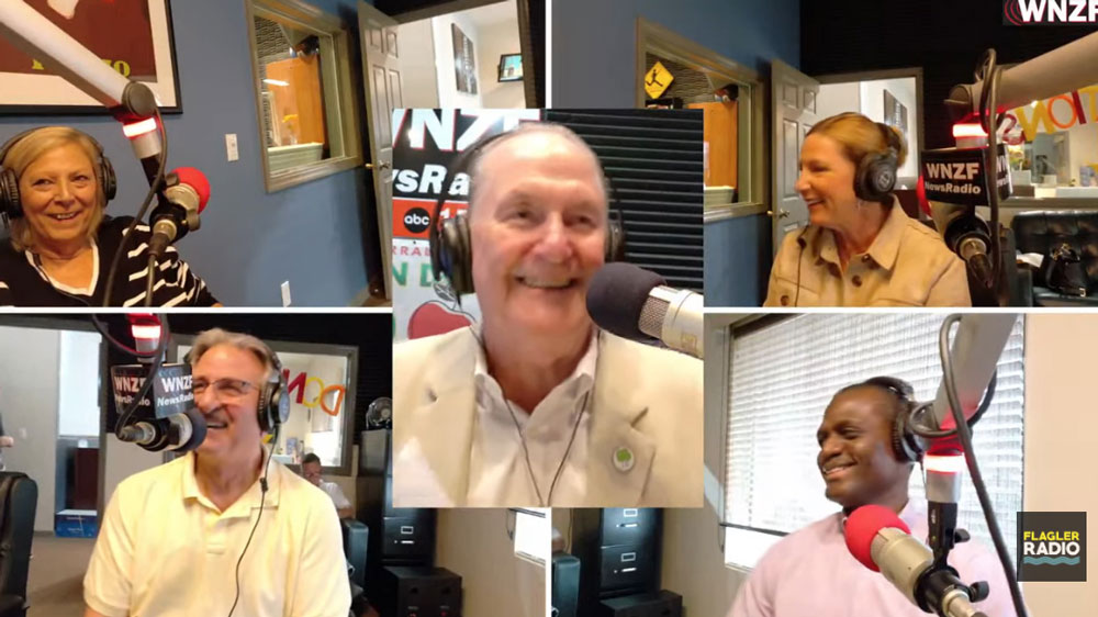They were all smiles after Flagler County's announcement on this morning's Food-A-Thon. Clockwise, from top left, Flagler County Commissioner Kim Carney, Flagler Broadcasting President David Ayres, Flagler County Administrator Heidi Petito and Deputy Administrator Percy Sayles, and Grace Community Food Pantry Director Charles Silano. (© FlaglerLive via YouTube)
