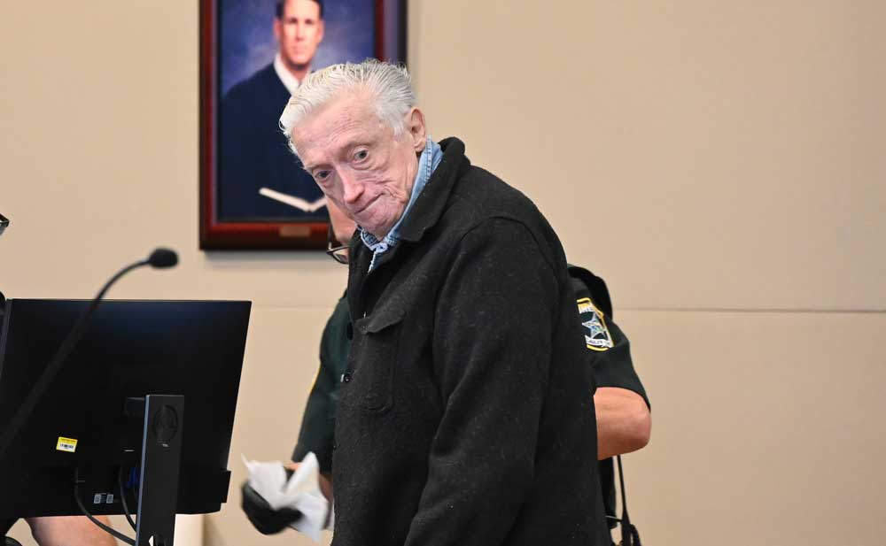 Edgar Alloway Jr. as he was getting fingerprinted at the end of his sentencing hearing just before noon today at the Flagler County courthouse. (© FlaglerLive)