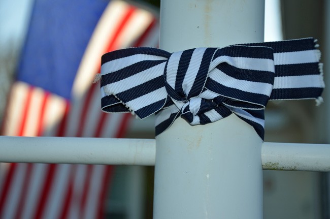 Mary Ann Dominessy Reese's campaign to bring awareness to ALS, after her December diagnosis, has spread to all 50 states with blue and white ribbons like this one, on one of innumerable lampposts in the Plantation Oaks community in Flagler Beach. (© FlaglerLive)