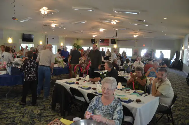 Diane Gullman in the foreground took tickets as people streamed in to Saturday's ALS fund-raiser at the Plantation Oaks clubhouse. Click on the image for larger view. (© FlaglerLive)