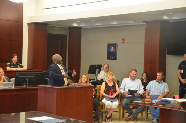 Bunnell City Manager Alvin Jackson, the keynote speaker at last week's Drug Court graduation, speaking to the four graduates--from left, Tara Williams, Pamela Guth, Alex Lape and Chad Dennis Jr. (© FlaglerLive)