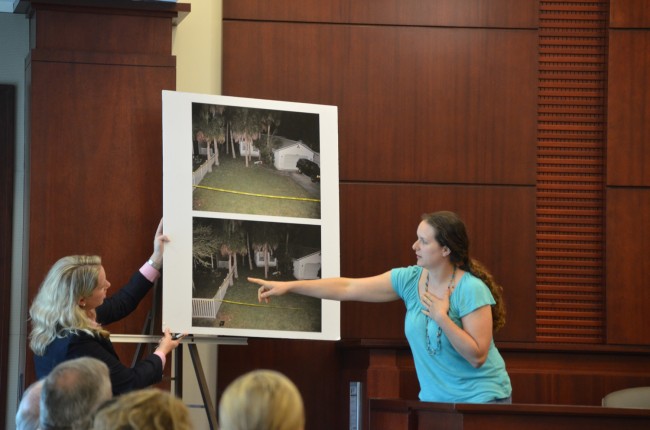 Amber Dibble, a witness who lives almost immediately across from the Dana Mulhall and Paul Miller properties, points to where she saw Miller standing after she heard "pop" sounds the evening of the shooting. (c FlaglerLive)