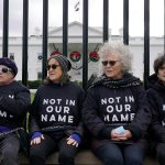 Activists with Jewish Voice for Peace gather to protest the Israel-Hamas war in Gaza and chain themselves to the fence outside the White House on Dec. 11, 2023.