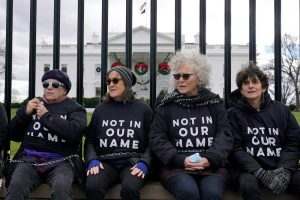 Activists with Jewish Voice for Peace gather to protest the Israel-Hamas war in Gaza and chain themselves to the fence outside the White House on Dec. 11, 2023.