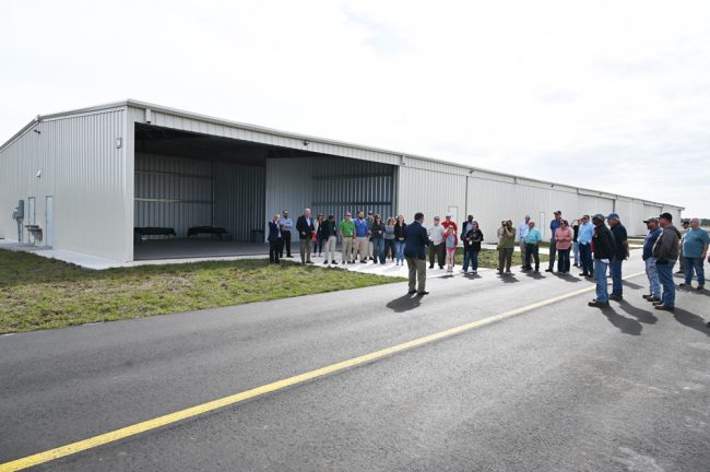 County Commission Chairman Andy Dance addressing the assembled near one of the new hangars this morning. (© FlaglerLive)