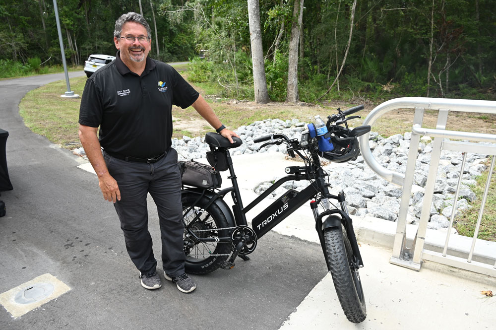 County Commission Chair Andy Dance, who also chairs the Community Traffic Safety Team, seen here with one of his ebikes, helped shape the ebike ordinance the Palm Coast City Council is crafting. (© FlaglerLive)