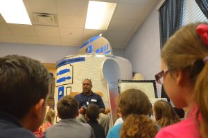 Anthony Cullins, president of the Bridge Building Program in Flagler, read to second graders. Click on the image for larger view. (© FlaglerLive)