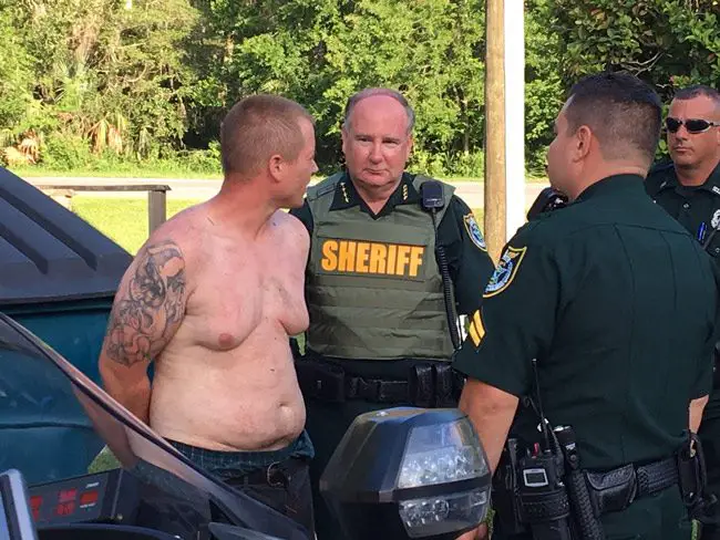Sheriff Rick Staly with the suspect shortly after he was apprehended in the area of Colbert Lane and Palm Coast Parkway early this evening. (FCSO)