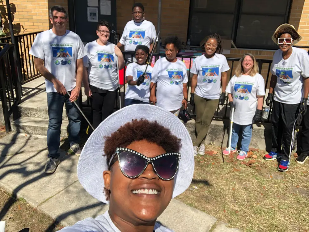 Tyona Ash in the foreground takes a selfie of the volunteers who cleaned up Martin Luther King Jr. Avenue in Bunnell today. (Tyona Ash)