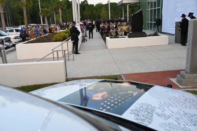 The ceremony drew about 150 people at the Sheriff's Operations Center, where the Celico family brough in the late Frankie Celico's patrol car, covered in his colleagues' testimonies. (© FlaglerLive)