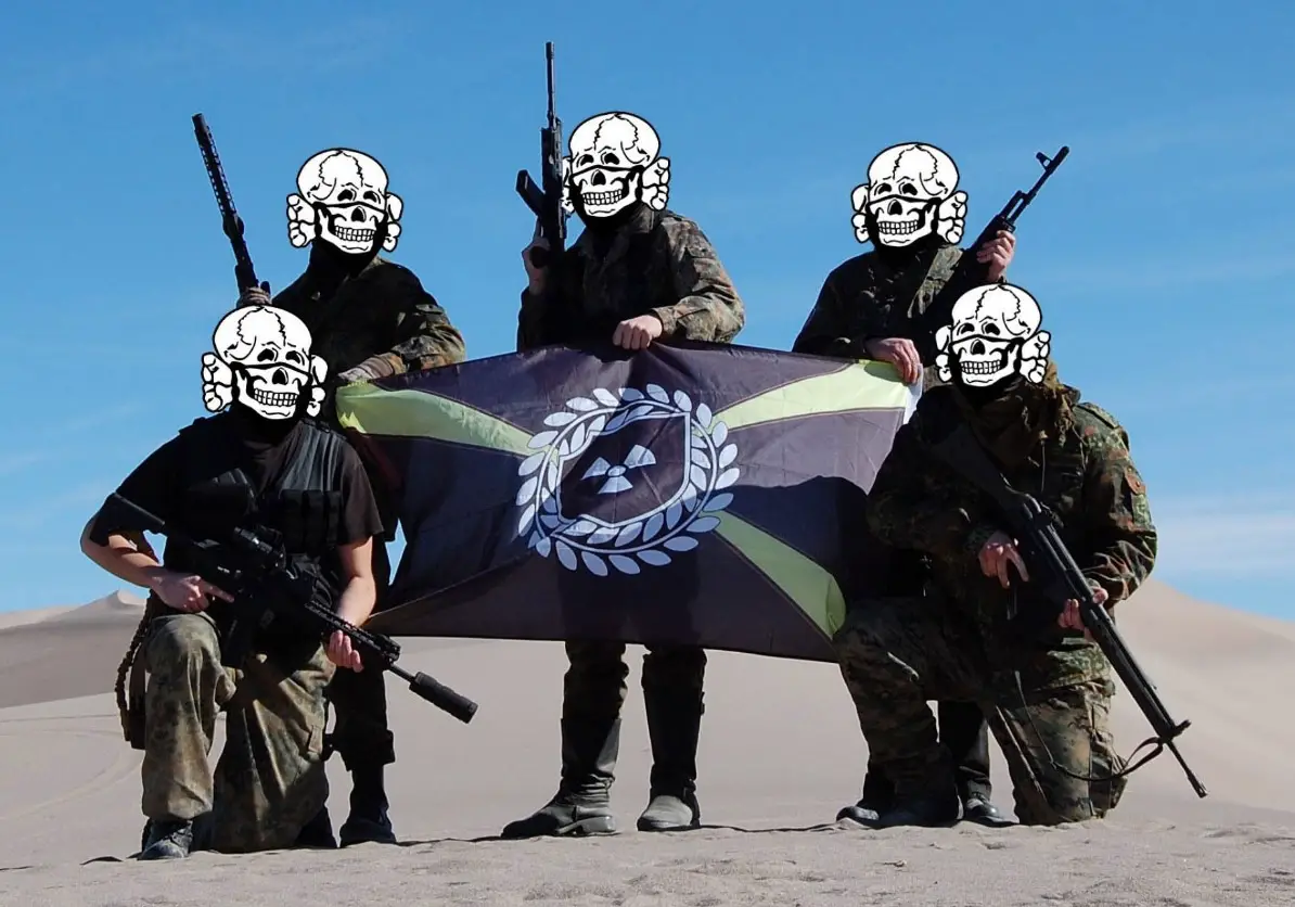 In a photo obtained by ProPublica, armed Atomwaffen members pose in the desert in Nye County, nev., during a weapons training session last month. They called the three-day gathering the Death Valley Hate Camp.