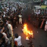 Supporters of a Pakistani religious group burn an effigy depicting the former spokeswoman of India’s ruling party, Nupur Sharma, during a demonstration in Karachi, Pakistan. (AP Photo/Fareed Khan)