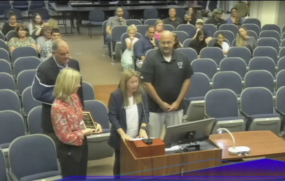 Anthony Zaksewicz, right, who has been teaching in Flagler County schools for 17 years, when he was honored by the local school board for being the recipient of a state teaching award last year. (© FlaglerLive via Flagler Schools TV)